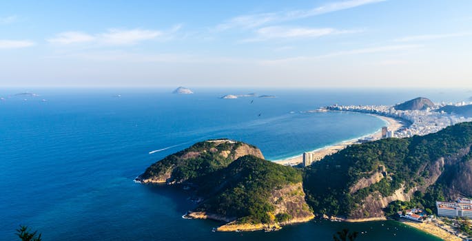 Breathtaking aerial view of Rio de Janeiro's coastline with lush hills and vibrant cityscape.